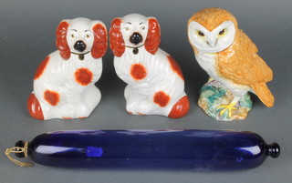 A Beswick figure of an owl 8", a pair of Staffordshire Victorian style ochre spaniels and a 19th Century blue glass rolling pin 15" 