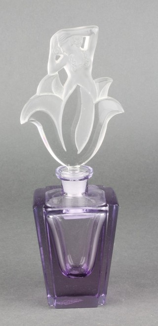 An Art Deco scent bottle, the opalescent stopper in the form of a semi-clad lady on a tapered amethyst glass base 9"
