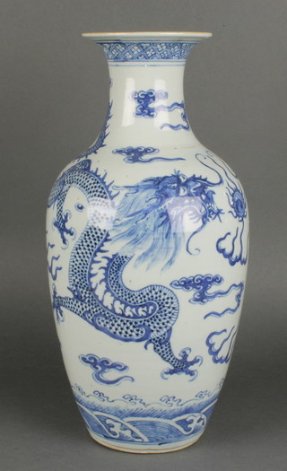 A late 19th Century Chinese oviform vase with waisted neck, the blue and white decoration with dragons chasing the flaming pearl 17" 