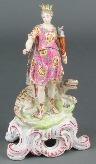 A 19th Century continental porcelain figure of a warrioress standing beside a crocodile on a raised rococo base 11"