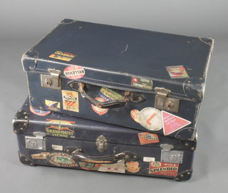 A Globetrotter blue suitcase bearing numerous labels including Grand Hotel Vienna, Splendid Hotel Nice, New Yorker and others 8" x 25 1/2" x 15" and 1 other blue suitcase with numerous labels including Royal Piccadilly etc 9" x 24" x 14" 