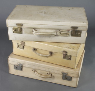 A parchment suitcase with brass locks 7"h x 24"w x 14"d, 1 other with chrome locks 7"h x 24"w x 14"d and 1 other with brass locks 7"h x 22"w x 14"d 