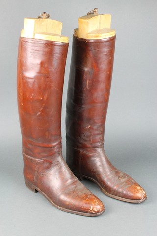 A pair of brown leather riding boots complete with trees