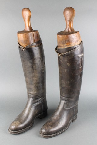 A pair of black leather riding boots complete with trees 