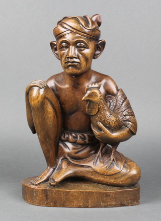 A Balinese carved hardwood figure of a seated gentleman and cockerel, the base marked Klung Kung Bali 12"h 