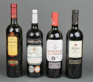 A bottle of 2003 Vina Albali Reserva, a bottle of 2002 Baturrica Tarragona, a bottle of 2009 Castillo La Paz Tempranillo Syrah and a bottle of 2009 Tempranillo MarquÃƒÂ©s de Villanueva  