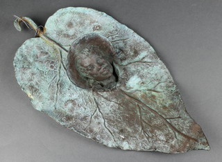 A bronze leaf shaped plaque decorated head of a bonneted gentleman 19"  together with a pair of Burmese book ends