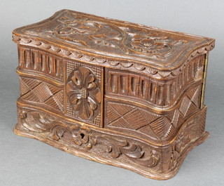 A shaped carved wooden trinket box, the interior containing numerous ivory game counters 