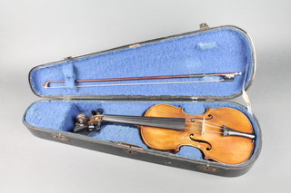 A half size violin 11 1/2", bears label Copie de Stradivarius Faciebat Anno 1721, complete with bow and wooden carrying case 