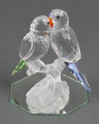 A Swarovski group of parrots on a branch 3" with mirrored base and box