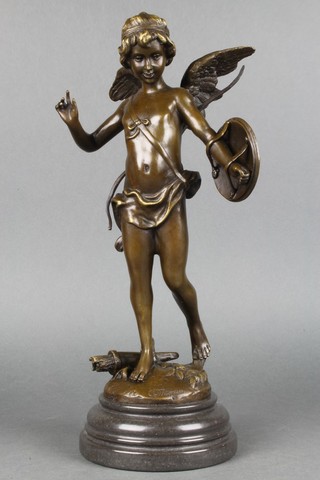 A bronze figure of a standing classical cherub with shield 15", raised on a circular marble base 