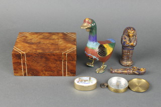 A cloisonne figure of a standing goose 5", a  miniature compass with silver dial 2", a pill box decorated the Houses of Parliament and a resin sarcophagus with Mummy, all contained in a walnut box 