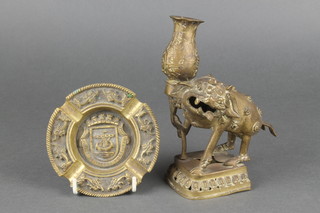 A Chinese bronze candlestick supported by a mythical base 7" together with a circular gilt metal Portuguese ashtray 4" 