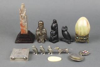 A carved Chinese soapstone figure in the form of a seated Deity, raised on a stepped wooden base 4", 4 miniature polished steel figures of animals and other curios 