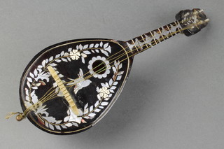 A mother of pearl, tortoiseshell and white metal mounted musical box in the form of a mandolin (f) 10" 