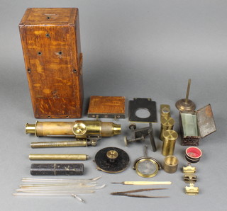 A 19th Century brass single pillar students microscope with slides etc 