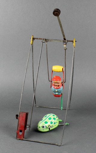 A tin plate and plastic figure of a trapeze artist together with a Japanese Alco clockwork figure 
