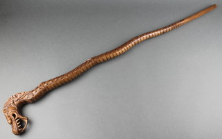 A Chinese carved hardwood stick in the form of a dragon 