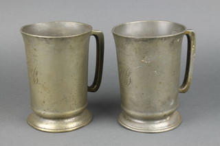 A pair of Victorian pewter measures marked H Mathews & Sons London