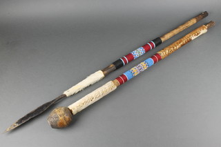 A Zulu style leaf shaped spear and a knobkerry both with hide and bead work banding 