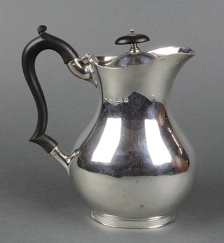 A silver baluster hot water jug with ebony mounts, Sheffield 1928, 520gr gross