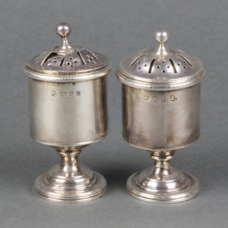 A matched pair of silver peppers of plain form London 1806 and 1938 110gr