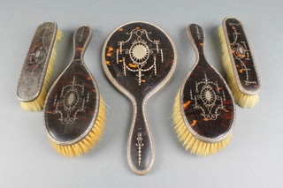 An Edwardian silver and tortoiseshell pique brush set comprising hand mirror, 2 hair and 2 clothes brushes Birmingham 1910
