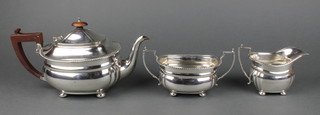 An Art Deco silver 3 piece tea set with gadroon rims and fruitwood handles, London 1936, gross 1050gr