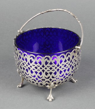 A Victorian pierced silver swing handled basket with blue glass liner, Sheffield 1870