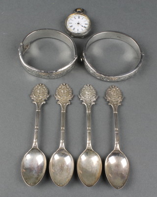 Four fancy silver tea spoons, two bangles and a fob watch