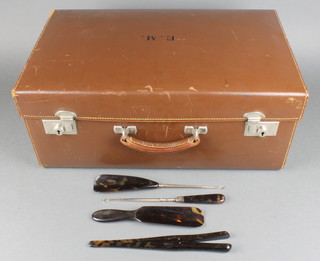 A toilet case containing 4 tortoiseshell accessories