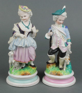 A pair of 19th Century Continental figures of a lady and gentleman with dogs 9"