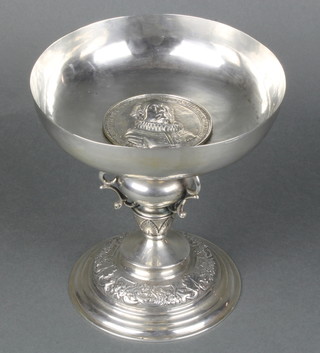 A late 19th Century Continental silver tazza with cast portrait medallion the baluster stem with 3 dragons, on a raised repousse base 658gr 7 1/2"