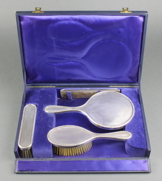 A cased engine turned silver 4 piece brush set London 1956