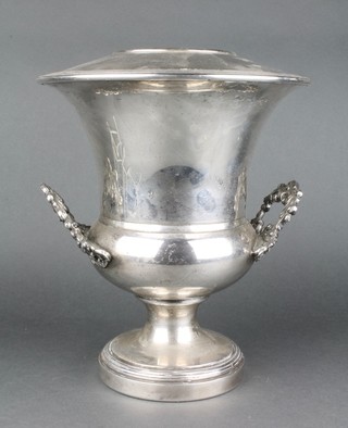 A silver plated urn shaped champagne cooler with scroll handles and waisted base 12" 
