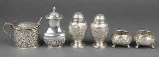 A repousse silver mustard, a ditto pepper and a 4 piece Indian silver condiment, 335 grams 