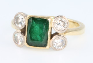An 18ct yellow gold emerald and diamond ring, the rectangular centre stone flanked by 4 brilliant stones, size K 