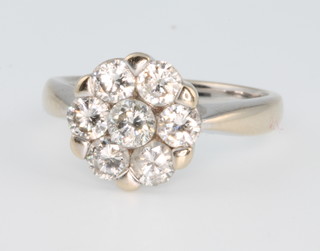 An 18ct white gold 7 stone diamond cluster "daisy" ring, size N