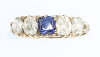 An 18ct yellow gold diamond 4 and sapphire 1 stone ring size O