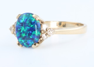 A yellow gold opal and diamond ring size O . 