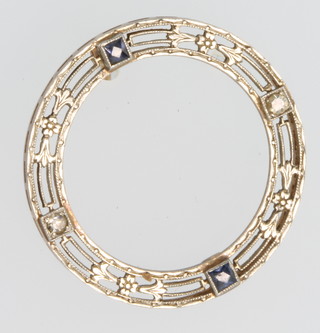 An Art Deco style yellow and white gold open brooch set with 2 diamonds and 2 sapphires 