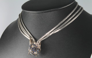 A 1970's 18ct white gold and sapphire set necklace, 50 grams