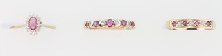 A 9ct yellow gold ruby and diamond half eternity ring size M, a ditto size N and an oval cluster ditto size N 