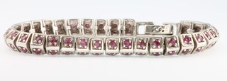 A gem set white metal bracelet