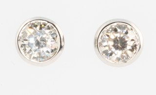 A pair of 18ct white gold single stone diamond earrings, approx. 0.5ct each 