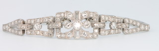 An Art Deco platinum diamond set articulated bracelet with baguette brilliant and rose cut stones 