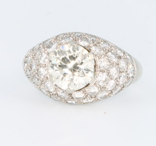 A white gold bombe diamond ring, the centre brilliant cut stone approx 1.55ct surrounded by small pave set diamonds, size H 