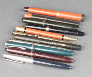 An Art Deco Parker fountain pen with orange case and black lid, minor pens and pencils