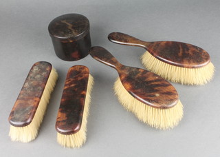 A tortoiseshell backed brush set comprising 2 hair brushes, 2 clothes brushes, a circular trinket box and minor items