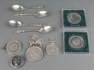 An 1889 crown mounted as a pendant on a silver chain and minor coins and spoons